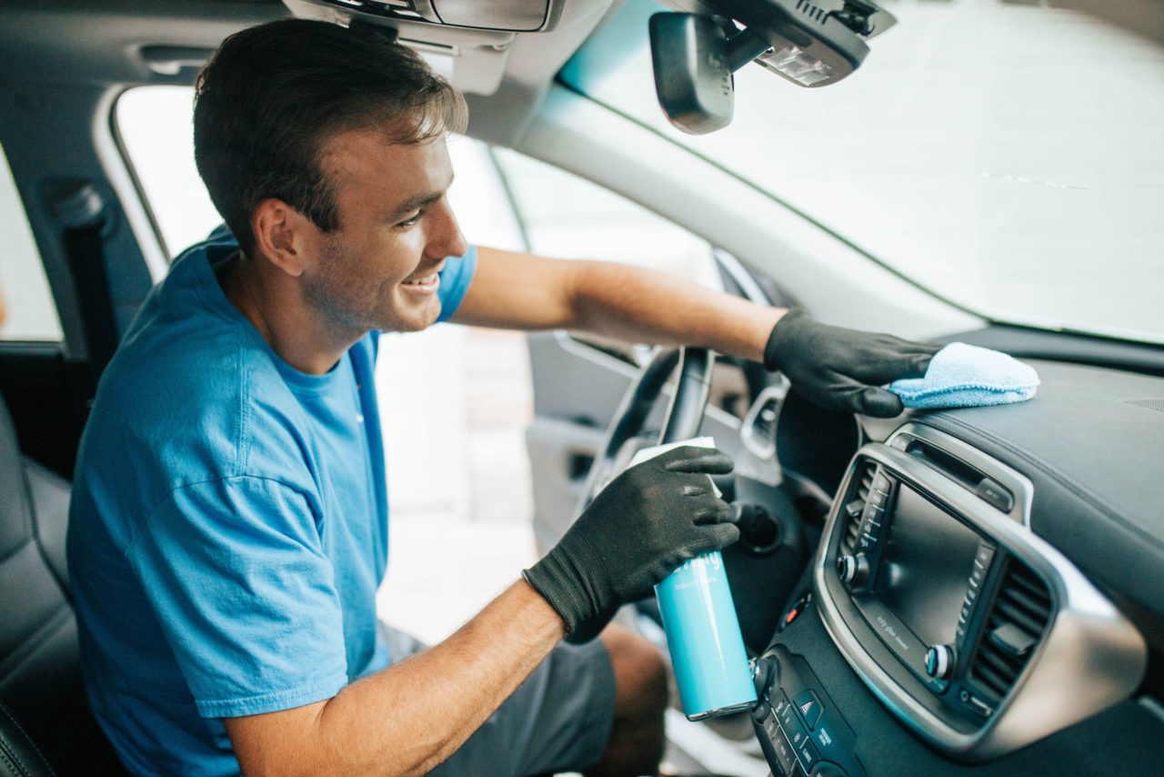 Image of employee cleaning car interior