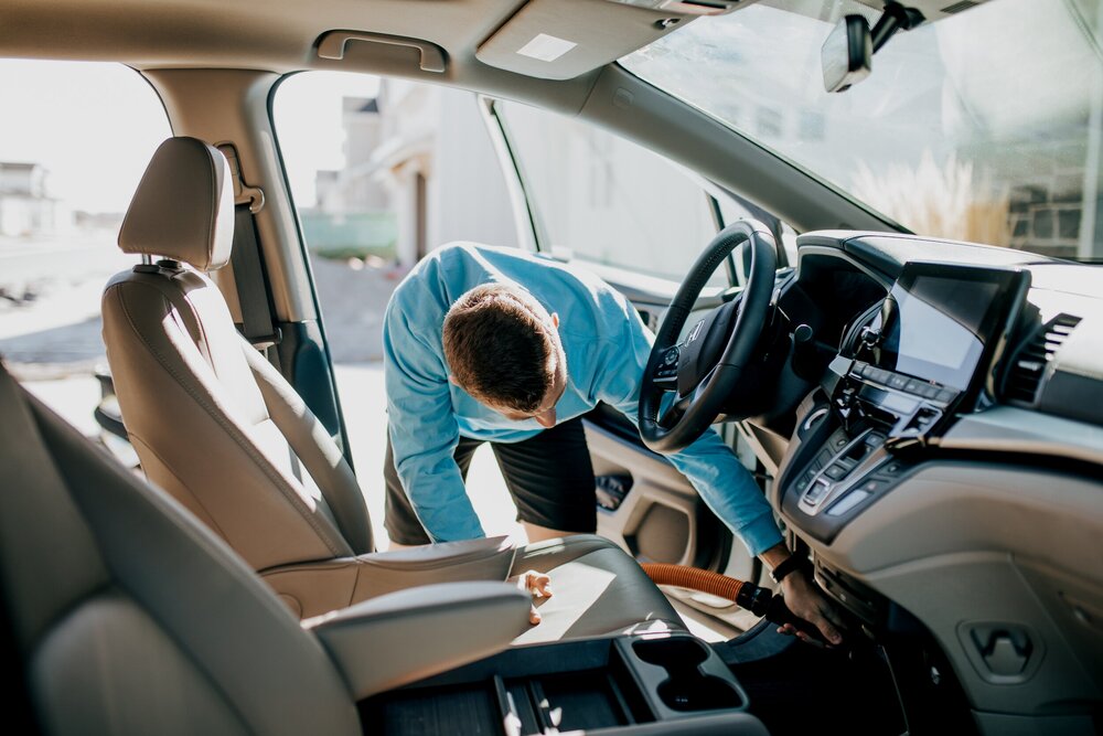 Homepage hero image of employee cleaning car